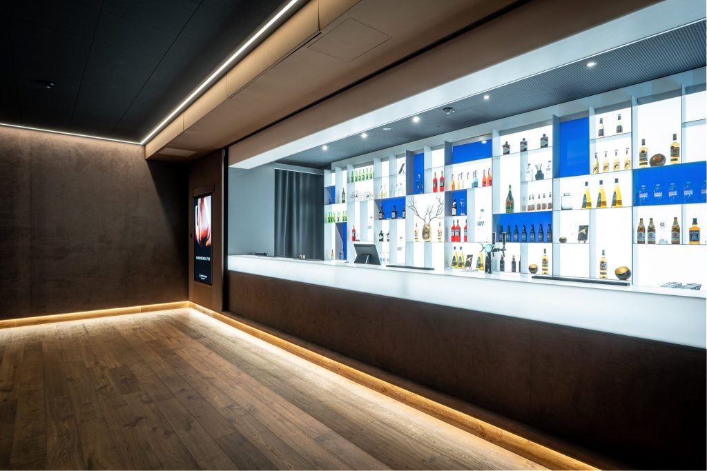Vue intérieure du bar élégant au Cinedome St. Gallen avec une sélection de boissons.