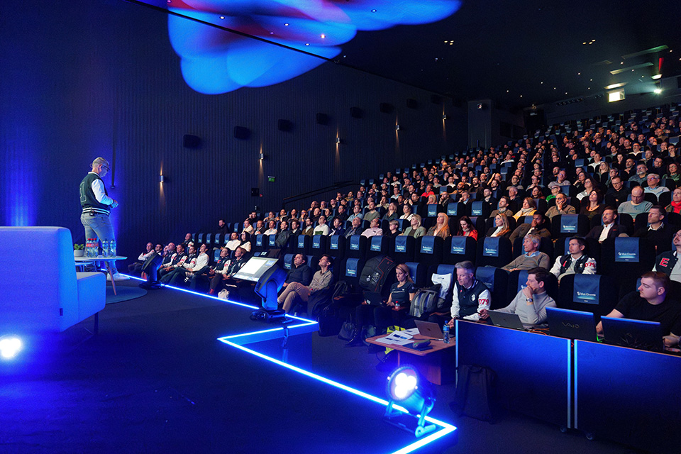 Modern event venue during a business presentation with a full audience.