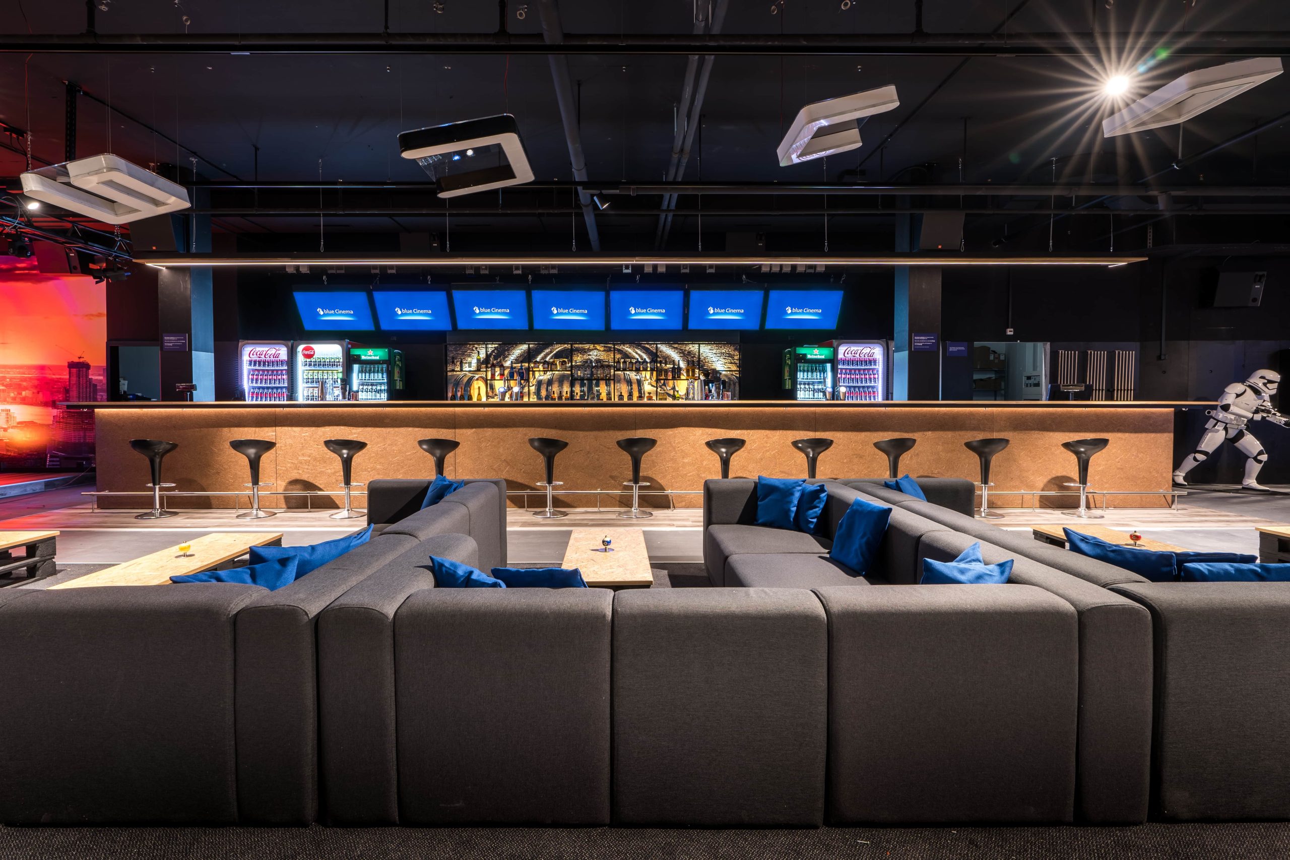 Chic blue Cinema sports bar with comfortable seating and a well-stocked bar area.